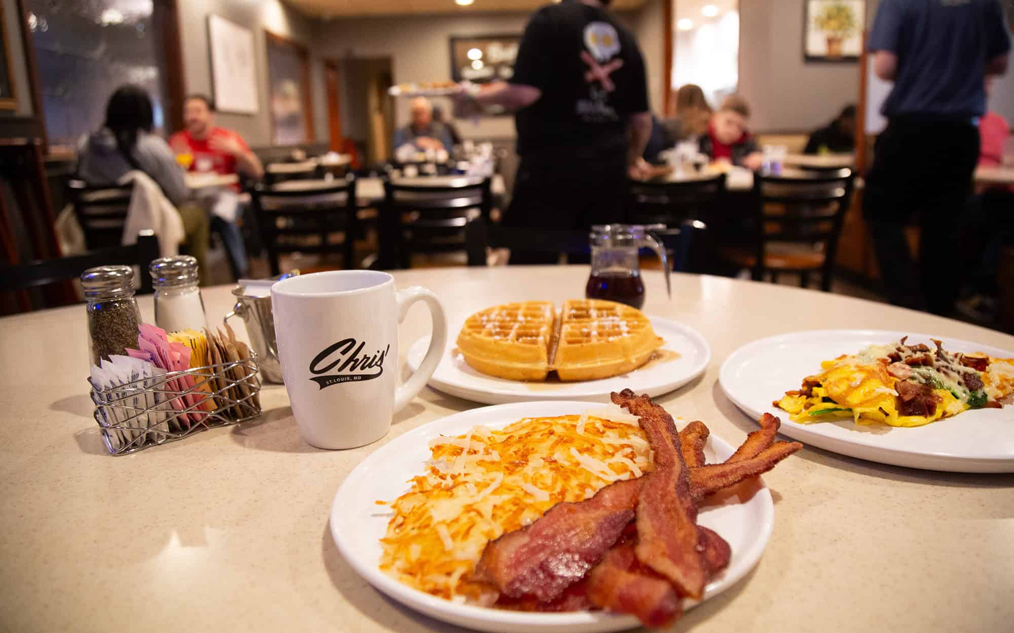 Waffles, Omelette, Hash Browns, and Bacon on Table